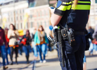 city safety and security. policeman watching order in the urban street - ph credits: AdobeStock